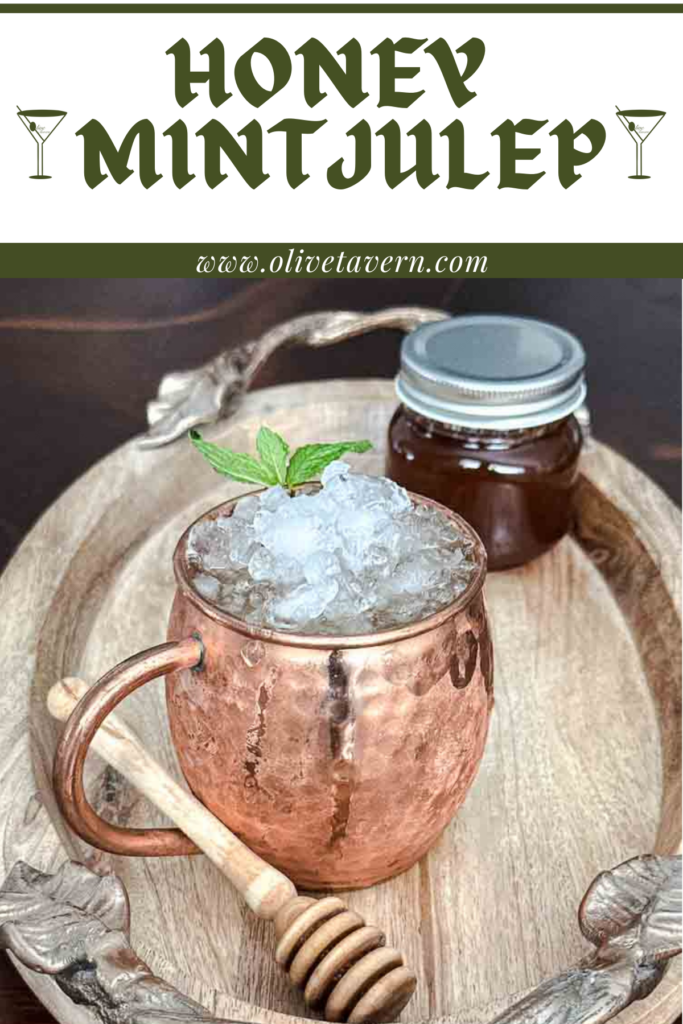 Honey Mint Julep Cocktail in copper cup with a Jar of honey.