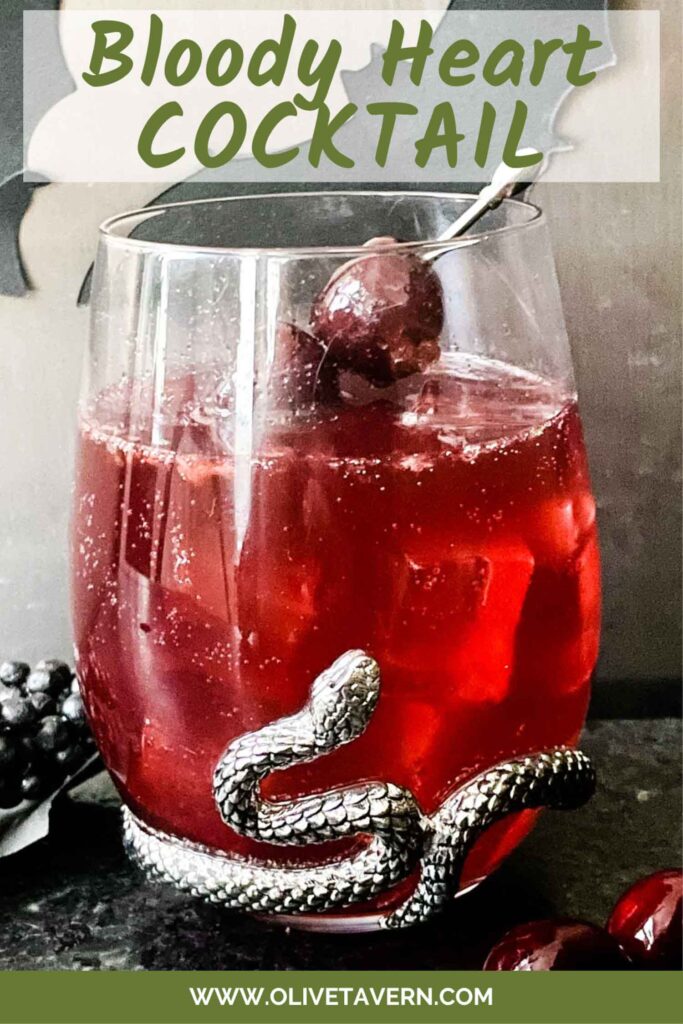 Pin of Bloody Heart Halloween Cocktail made with vodka, cherry, citrus, and mint. A red cocktail drink recipe.