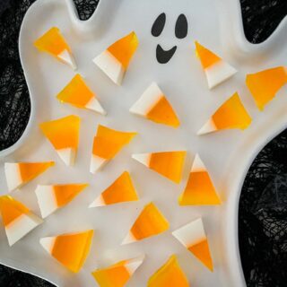 A white ghost plate full of Halloween Candy Corn Jello Shots