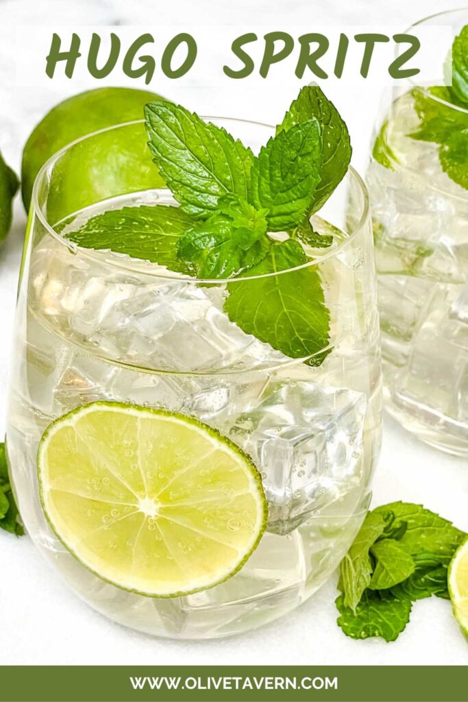 Pin of a Hugo Spritz cocktail with fresh mint and limes, and title at top