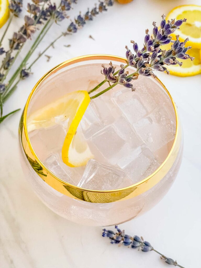 A round glass full of Lavender Field Mocktail on a white counter